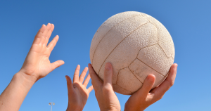 Girls hands catching netball